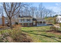 Charming two-story home featuring a cozy front porch and well-manicured lawn at 7209 Kilcullen Dr, Charlotte, NC 28270
