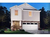 Charming two-story home featuring stone accents, white trim, and an attached two-car garage at 837 Blue Canyon Dr, York, SC 29745