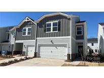Charming two-story home with attached garage, modern siding, and manicured front lawn in a cozy neighborhood at 1735 Braemar Village Dr, Monroe, NC 28110