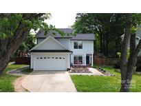 Charming two-story home features a well-maintained front yard and attached two-car garage at 3516 Mill Stream Ct, Charlotte, NC 28209