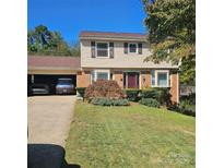 Charming two-story home with well-manicured lawn, brick accents, and an attached garage at 5516 Northwood Dr, Hickory, NC 28601