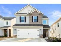 Charming two-story home boasts a two-car garage, neutral siding, and a welcoming facade at 5775 Soft Shell Dr, Lancaster, SC 29720