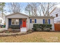 Charming single-story brick home with red front door, red railings, and cozy curb appeal at 831 Spruce St, Charlotte, NC 28203