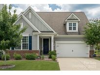 Charming home featuring a well-manicured lawn, inviting front porch, and a two-car garage at 108 Hillston Ln, Mooresville, NC 28115