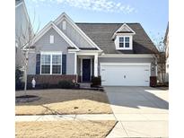 Charming single-Gathering home featuring a well-manicured lawn, two-car garage and beautiful curb appeal at 108 Hillston Ln, Mooresville, NC 28115