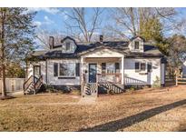 Charming front exterior with covered porch, dormer windows and inviting entrance at 1208 Fordham Rd, Charlotte, NC 28208