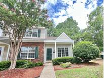 Charming townhome with a well-manicured lawn, featuring brick accents and lush greenery at 12906 Sickles Dr, Charlotte, NC 28273