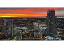 Stunning twilight cityscape view featuring modern high-rise buildings against a vibrant, colorful sky at 210 N Church St # 3606, Charlotte, NC 28202