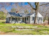 Charming single-story home featuring a classic design, manicured lawn, and inviting front porch at 2478 Stribling Cir, Lancaster, SC 29720
