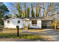 Charming single-story home with white siding, a covered carport and a well-maintained front yard at 2706 Booker St, Gastonia, NC 28054