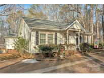 Exterior view of the home featuring a charming front porch and detailed landscaping at 530 Wilmot Trl, Gastonia, NC 28056