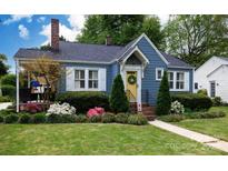 Charming home featuring a meticulously landscaped front yard, walkway, yellow door, and blue siding at 968 Waverly Ave, Rock Hill, SC 29730