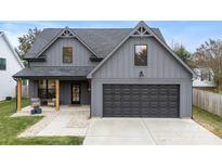 Charming gray two-story home with a modern design, a two-car garage, and a welcoming front porch at 11352 Timber Ridge Rd, Charlotte, NC 28213