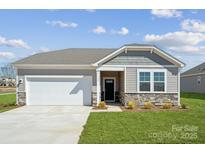 Charming single-story home with a manicured lawn, stone accents, and an attached two-car garage on a sunny day at 1137 Hallman Branch Ln, Lincolnton, NC 28092