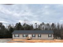 Charming single-story home featuring a cozy front porch and neat landscaping at 133 Plank Barn Ln, Stony Point, NC 28678