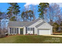 Charming single-story home featuring a well-manicured lawn, attached garage, and classic vinyl siding at 2146 Mallard Green Pl, Charlotte, NC 28262