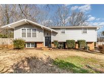 Charming split-level home featuring light gray siding, an A-frame roof, and a well-maintained front yard at 4000 Elizabeth St, Hickory, NC 28601