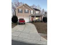 Two-story home with neutral siding, red truck in driveway, and a well-manicured front lawn at 8718 Buttonwood Ct, Charlotte, NC 28215