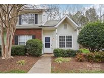 Charming two-story townhome featuring brick accents, vinyl siding, and mature landscaping at 9160 Exbury Ct, Charlotte, NC 28269