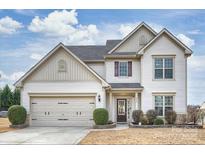 Charming two-story home featuring a two-car garage and beautifully landscaped front yard at 1035 Ivey Ct, Fort Mill, SC 29707