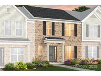 Charming two-story townhome showcasing a brick facade, black shutters, and inviting front door at 2232 Cobble Ct # 153, Monroe, NC 28110