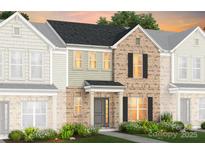 Charming brick townhome with a well-manicured lawn and inviting entrance at 2236 Cobble Ct # 151, Monroe, NC 28110