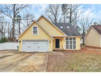 Charming yellow single-story home featuring an attached garage and well-maintained front yard at 2321 Heathershire Ln, Matthews, NC 28105