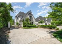 Stunning two-story home with a gated driveway and manicured landscaping, offering both privacy and curb appeal at 1328 S Kings Dr, Charlotte, NC 28207
