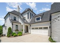 Beautiful traditional home featuring a large garage, manicured landscaping, and a modern architectural design at 1328 S Kings Dr, Charlotte, NC 28207