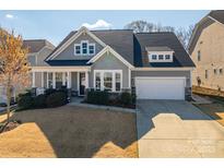 Charming two-story home featuring gray siding, stone accents, well-maintained landscaping, and an attached two-car garage at 146 Stibbs Cross Rd, Mooresville, NC 28115