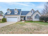 Charming two-story home with a well-manicured lawn and attached two-car garage at 1750 Williamsburg Dr, Rock Hill, SC 29732