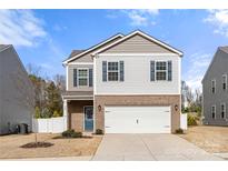 Charming two-story home featuring a brick-accented facade, attached two-car garage, and lovely curb appeal at 225 Final Stretch Ln # 19, Clover, SC 29710