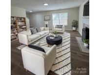 Bright living room featuring modern furniture, fireplace, and a stylish area rug at 2303 Hope Valley Ln, Charlotte, NC 28213
