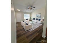 Bright living room with vaulted ceiling, modern furnishings and wood-look flooring at 2307 Hope Valley Ln, Charlotte, NC 28213