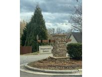 A stone Stagecoach Station entrance sign is framed by mature trees and landscaping at 3121 Strong Box Ln, Gastonia, NC 28052