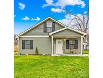 Charming two-story home featuring a welcoming front porch and a lush green lawn at 1075 Wellman St, Gastonia, NC 28054