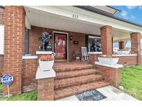 Charming brick front porch featuring lion statues, brick columns, and a welcoming entrance at 111 Bethpage Rd, Kannapolis, NC 28081