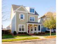 Charming two-story home boasts a classic design, well-manicured lawn, and inviting front porch, enhancing its curb appeal at 13616 Jacks Ln, Pineville, NC 28134