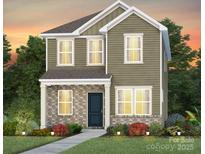 Charming two-story home with a brick and vinyl facade, complemented by a well-manicured front yard at 14036 Penbury Ln # 333, Charlotte, NC 28278