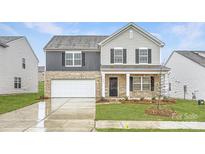 Charming two-story home with brick and vinyl siding, a two-car garage, and a well-maintained front yard at 1417 Pine Heart Dr, Edgemoor, SC 29712