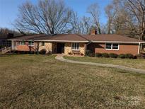 Charming single-story brick home with manicured lawn and stone accents at 1807 Brantley Rd, Kannapolis, NC 28083