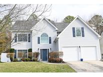 Charming two-story home with a well-manicured lawn, blue shutters, and a two-car garage at 2043 Covered Bridge Ct, Rock Hill, SC 29732