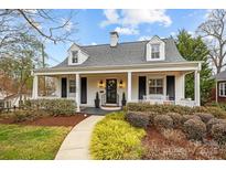 Charming home featuring a covered front porch, dormer windows and a professionally landscaped yard at 2840 Hillsdale Ave, Charlotte, NC 28209