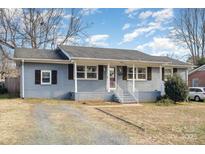 Attractive single story home with brick veneer, dark shutters, and a well-maintained lawn at 4930 Crestmont Dr, Charlotte, NC 28205