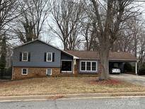 Charming single-story home with a brick and siding facade, complimented by a covered carport for convenient parking at 818 W 6Th St, Newton, NC 28658