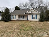 Charming one-story home featuring blue shutters and a cozy front porch at 823 Prestwick Dr, Rock Hill, SC 29730