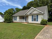 Charming single-story home featuring a well-manicured lawn, blue shutters, and a welcoming front porch at 823 Prestwick Dr, Rock Hill, SC 29730