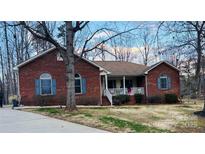 Charming brick home featuring blue shutters and a cozy front porch at 920 Hunting Ave, Lincolnton, NC 28092