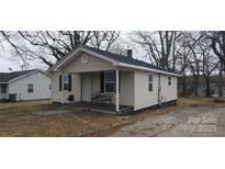 Charming single-story home with a cozy front porch and neutral siding at 1019 E Airline E Ave, Gastonia, NC 28054