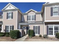 Inviting two-story townhome with neutral siding, dark shutters, and well-maintained landscaping at 14713 Lions Pride Ct, Charlotte, NC 28273